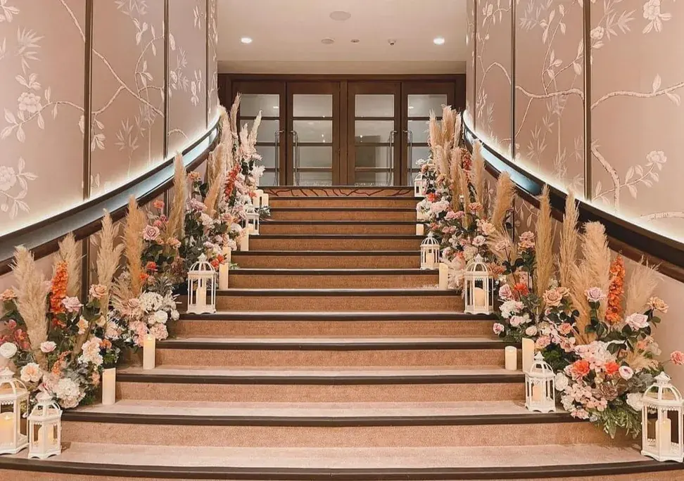XOXO floral styling along a venue staircase